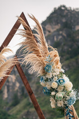 Wedding arch in the shape of a triangle with ears of grass