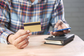 hand holding credit card and smart phone shopping online 