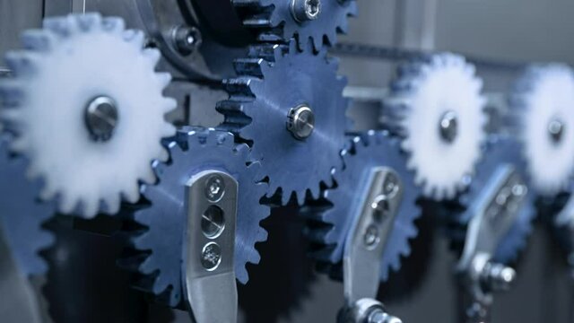 Close-up of steel gears spinning inside complex engine mechanism. Mechanics, teamwork, steampunk concept.