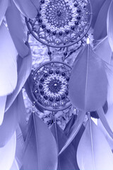 Handmade dream catcher with feathers threads and beads rope in very peri trendy color of the year 2022.