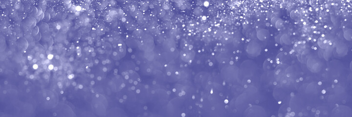 Trendy very peri color of the year 2022, violet blue sparkling glitter background, christmas texture. Abstract defocused header. Wide screen wallpaper. Panoramic web banner with copy space for design