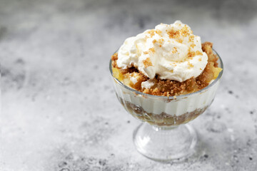 Apple trifle in a glass bowl on a light culinary background. Traditional Scandinavian aebletrifli on the kitchen table	