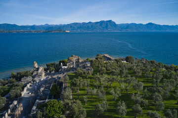 Fototapeta na wymiar Aerial view of the Grotte di Catullo ruins of a large Roman villa on the peninsula. The grottoes at the very peak of the Sirmione peninsula. Lake Garda, Italy.