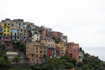 Fototapeta premium pastel italian houses on a mountain with a sky and cloudy background