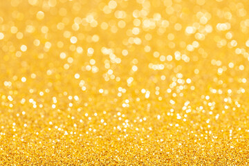 sparkles of yellow glitter abstract background. Copy space