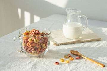 Delicious and healthy fruit cereal in glass bowl with milk.