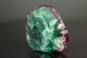 macro mineral stone green and purple fluorite on a black background