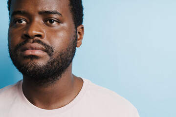 Black bristle man in t-shirt posing and looking at camera