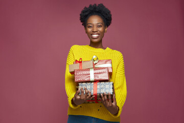 Happy african american woman hold wrapped birthday presents, smiling black girl congratulate with holiday by gift boxes