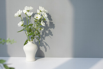 white porcelain vase with small chrysanthemum flowers.