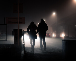 silhouette of a persons walking in the night