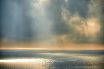 The smooth surface of the sea and clouds over the water. Early morning at sea. Seascape