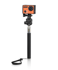 Modern orange action camera on a selfie stick, isolated
