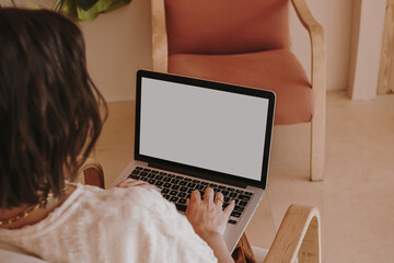 Fototapeta premium Aesthetic composition with young pretty woman work on laptop computer with copy space screen. Modern interior design