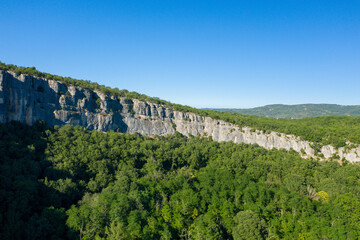 A cliff in the middle of the forest of the Gorges de lArdeche in Europe, France, Ardeche, in summer, on a sunny day.