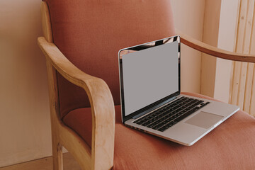 Laptop computer with blank copy space screen on chair