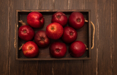 Ripe red apples in wooden box. Top view