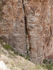 Steep sandstone rock wall s with vertical gap in majestic Grand Canyon displaying different geological ages, Grand Canyon, Arizona, USA