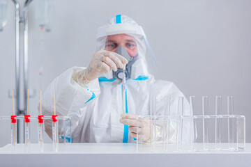 Medical worker in PPE working with COVID-19 test in hospital lab.