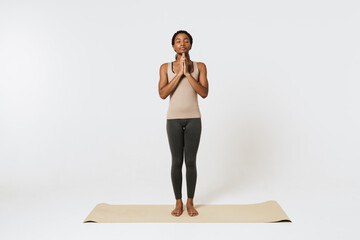 Young black woman meditating during yoga practice on mat