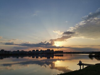 sunset over the river near city