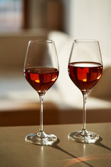 Two glasses of rosé wine, indoors