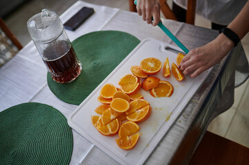 slicing oranges for a festive punch