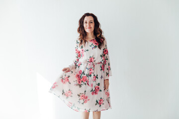 beautiful brunette woman 40 years old in a dress with flowers