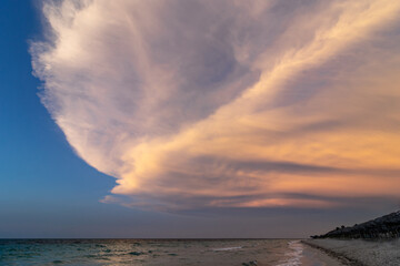 Beautiful sunset on the ocean shore in the evening