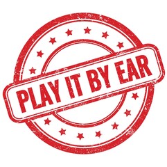 PLAY IT BY EAR text on red grungy round rubber stamp.