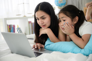 child girl person 2 sisters watching media and learning on laptop, online communication at home