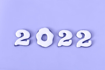 New Year's set of white gingerbread numbers 2022 toned in trendy very peri color. Isolated on very peri background. Top view.