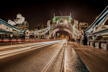 The iconic Tower Bridge in London, view to the illuminated Tower Bridge and skyline of London, UK, just after sunset.