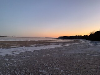 sunrise on the winter beach of the Volga river