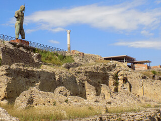 The Giant Bronze Colossus Man Statue in the Market Plaza in the City of Pompei, Italy, overlooking the Cliff from the Market Plateau