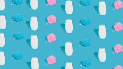 Spa and bath concept.  Pattern made of colorful bath sponges and shower gel. Trendy blue background.