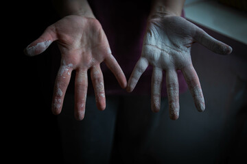beautiful women's hands smeared in white paint after working with their hands . home renovation....