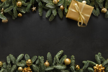 Christmas banner with gold gift, baubles, evergreen nobilis branches on black background with copy...