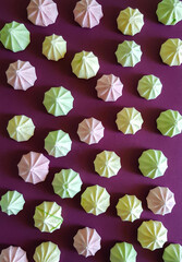 Meringue pattern on a purple background. The basis for the design with multicolored meringues.