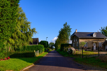 The street of the traditional French village of Saint Sylvain in Europe, France, Normandy, towards Veules les Roses, in summer, on a sunny day.