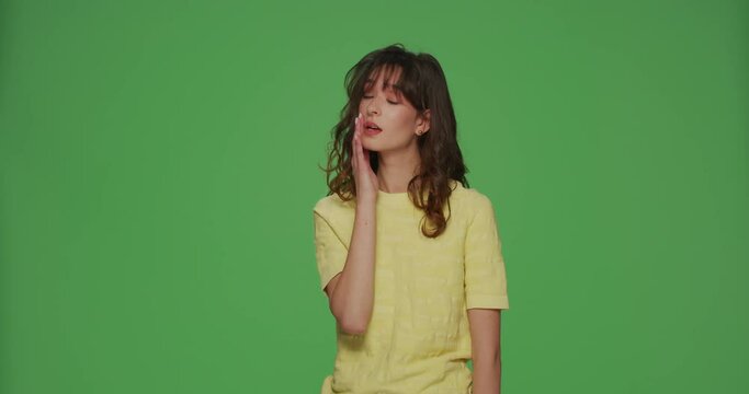 Young beautiful girl make facepalm gesture feeling regret, shame about forgotten event, bad memory on green background