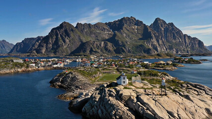 Fototapeta na wymiar Amazing nature of Lofoten Islands, Norway By Drone top view surrounded by norway sea green traditional district in the county of Nordland breathtaking scandinavian soccer mountain rock architecture