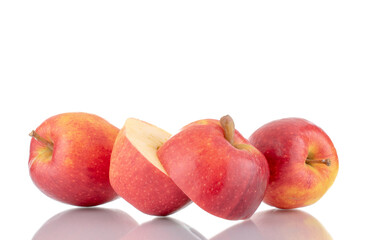 Two half and two whole organic red apples with a knife, close-up, isolated on white.