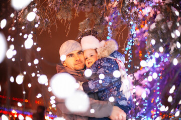 family winter holidays and celebration concept, happy father and little daughter at christmas...
