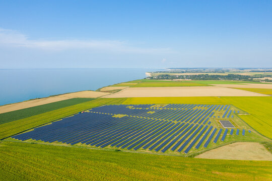 Norman solar panels in the middle of the flax fields towards Veules les Roses in Europe, France, Normandy, in summer, on a sunny day.