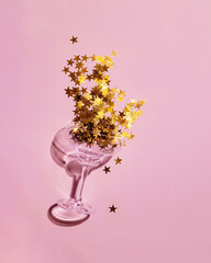 holiday glass with glitter on a pink background