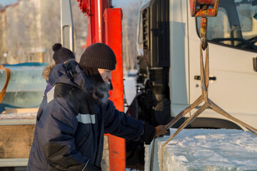 Fototapeta na wymiar Portrait of a worker in a black hat unloading