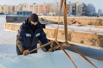 Portrait of a worker in a black hat unloading