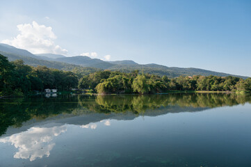 View of Ang Kaew reservoir with mountain and blue sky reflection on sunny day