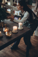 A woman makes a Christmas tree with her own hands. High quality photo